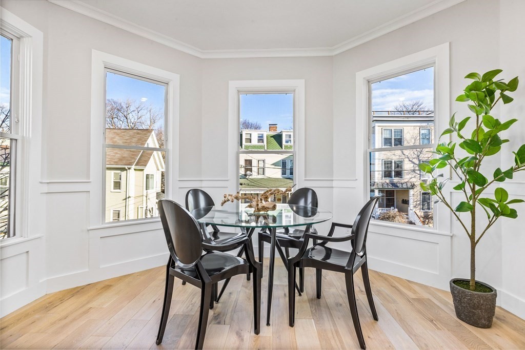14 Hillside Park, Unit 6 Somerville, MA 02143 - Photo 14 of 32 a view of a dining room with furniture window and wooden floor
