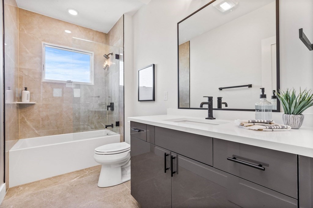 14 Hillside Park, Unit 6 Somerville, MA 02143 - Photo 16 of 32 a bathroom with a double vanity sink toilet mirror and bathtub