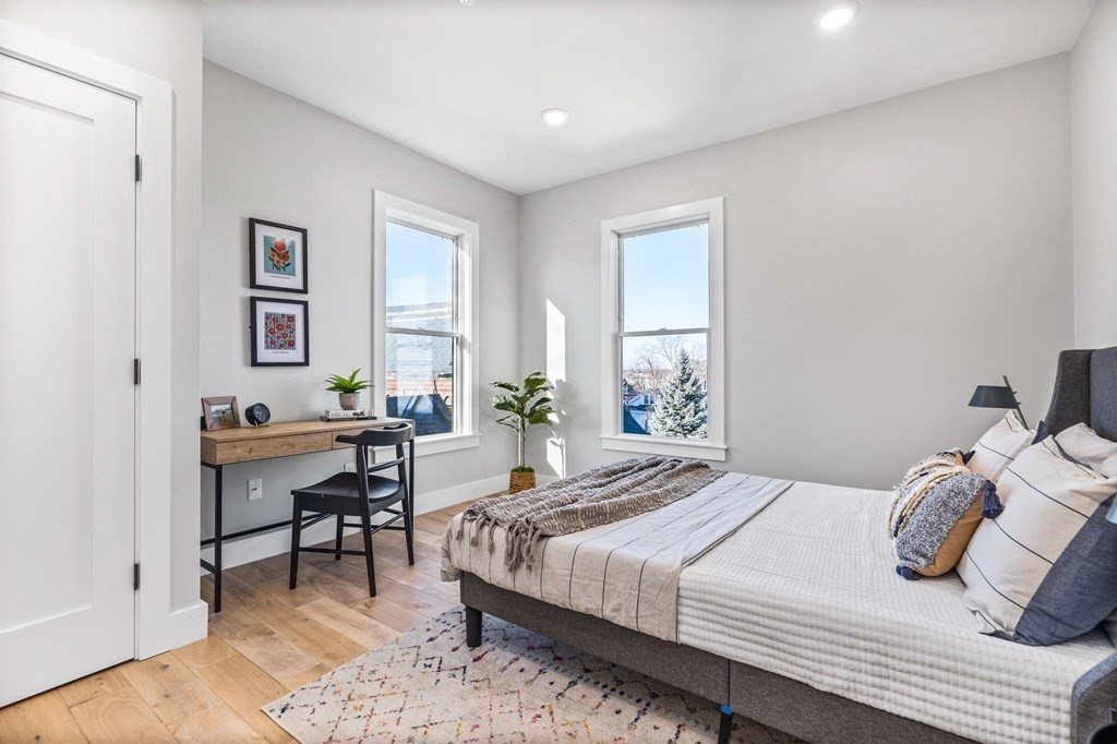 14 Hillside Park, Unit 6 Somerville, MA 02143 - Photo 19 of 32 a bedroom that has a bed and a table in it
