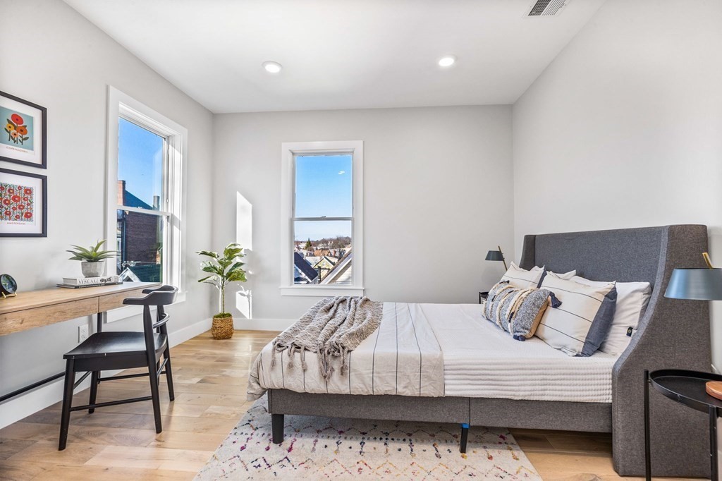 14 Hillside Park, Unit 6 Somerville, MA 02143 - Photo 20 of 32 a bedroom with a bed a bookshelf and a potted plant