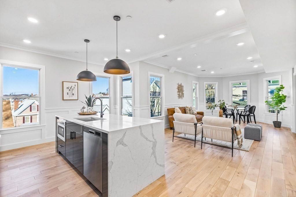 14 Hillside Park, Unit 6 Somerville, MA 02143 - Photo 2 of 32 a kitchen with stainless steel appliances granite countertop a stove and a wooden floors