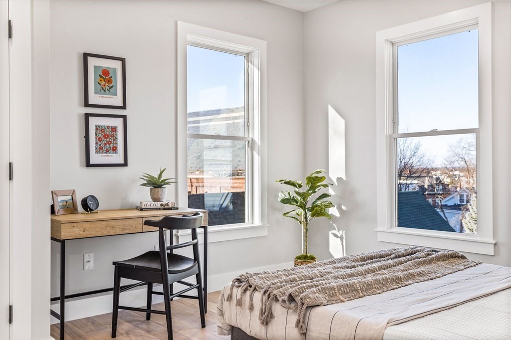 14 Hillside Park, Unit 6 Somerville, MA 02143 - Photo 22 of 32 a bedroom that has a bed and a table in it