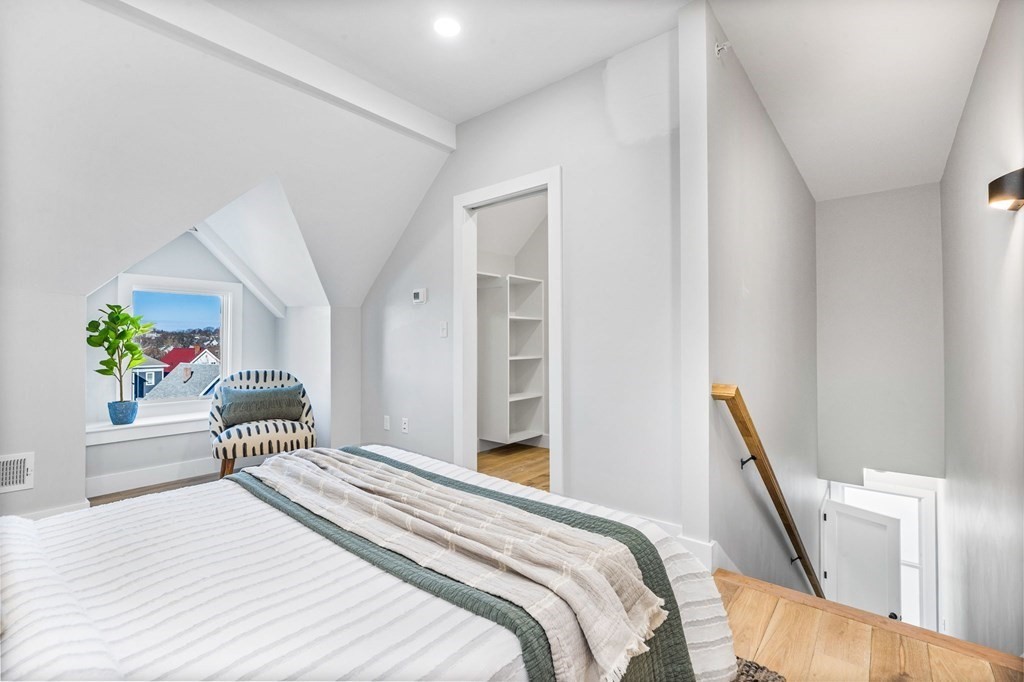 14 Hillside Park, Unit 6 Somerville, MA 02143 - Photo 24 of 32 a bedroom with a bed and a potted plant