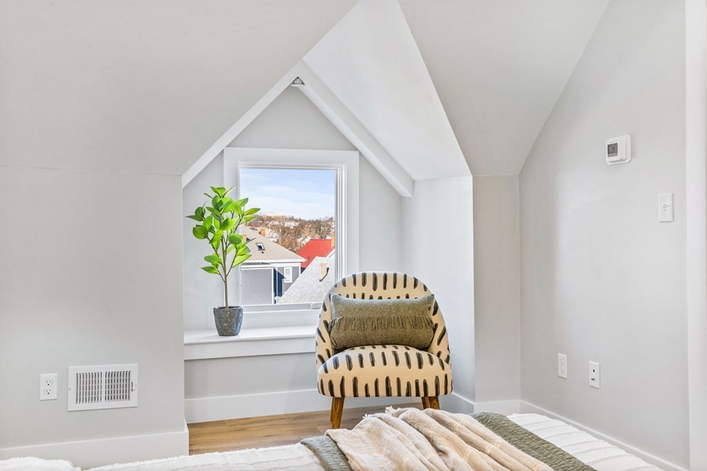 14 Hillside Park, Unit 6 Somerville, MA 02143 - Photo 25 of 32 a bedroom with a bed and a painting on the wall