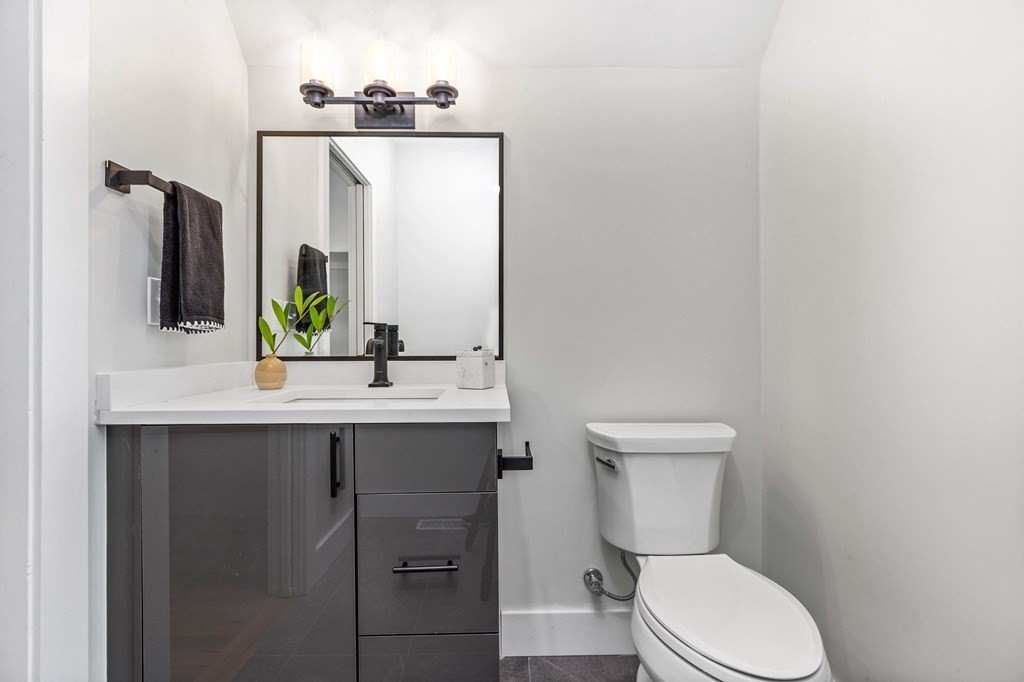 14 Hillside Park, Unit 6 Somerville, MA 02143 - Photo 30 of 32 a bathroom with a toilet sink and mirror