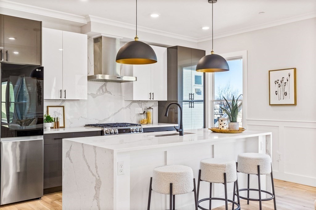 14 Hillside Park, Unit 6 Somerville, MA 02143 - Photo 7 of 32 a kitchen with stainless steel appliances granite countertop a sink a stove a refrigerator and wooden cabinets