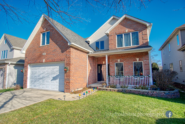 S643 Robbins Street Winfield, IL 60190 - Photo 1 of 40 a front view of a house with garden
