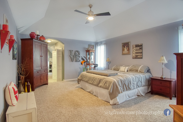 S643 Robbins Street Winfield, IL 60190 - Photo 14 of 40 a spacious bedroom with a bed and a chandelier