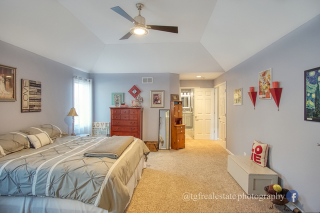 S643 Robbins Street Winfield, IL 60190 - Photo 15 of 40 a bedroom with a bed and a chandelier
