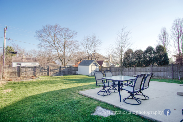 S643 Robbins Street Winfield, IL 60190 - Photo 37 of 40 a view of a backyard with table and chairs and a slide