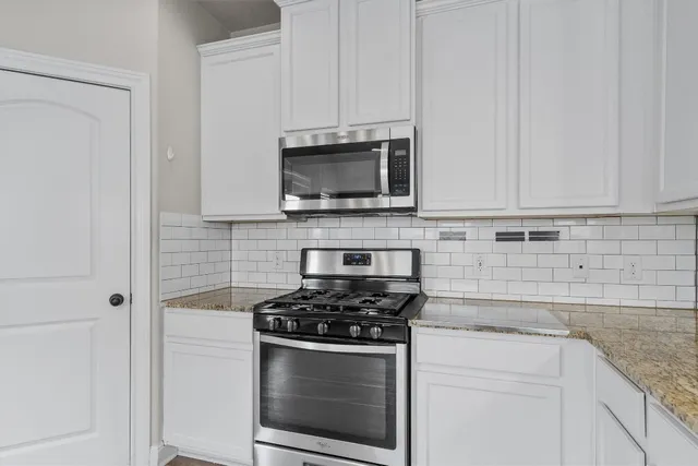 a kitchen with cabinets stainless steel appliances and a sink