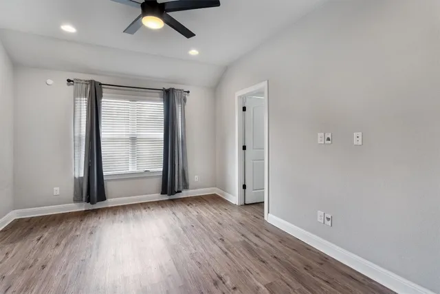 a view of an empty room and wooden floor