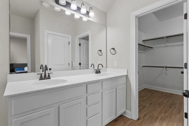 a bathroom with a double vanity sink and a mirror