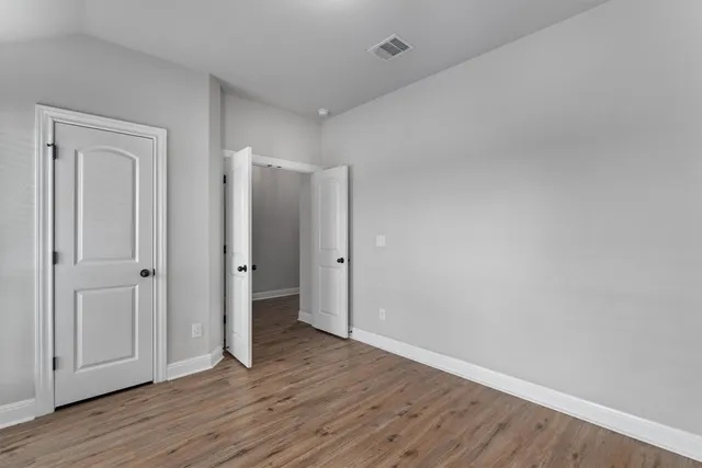 a view of an empty room and wooden floor