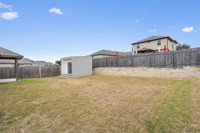a view of a back yard and a fence