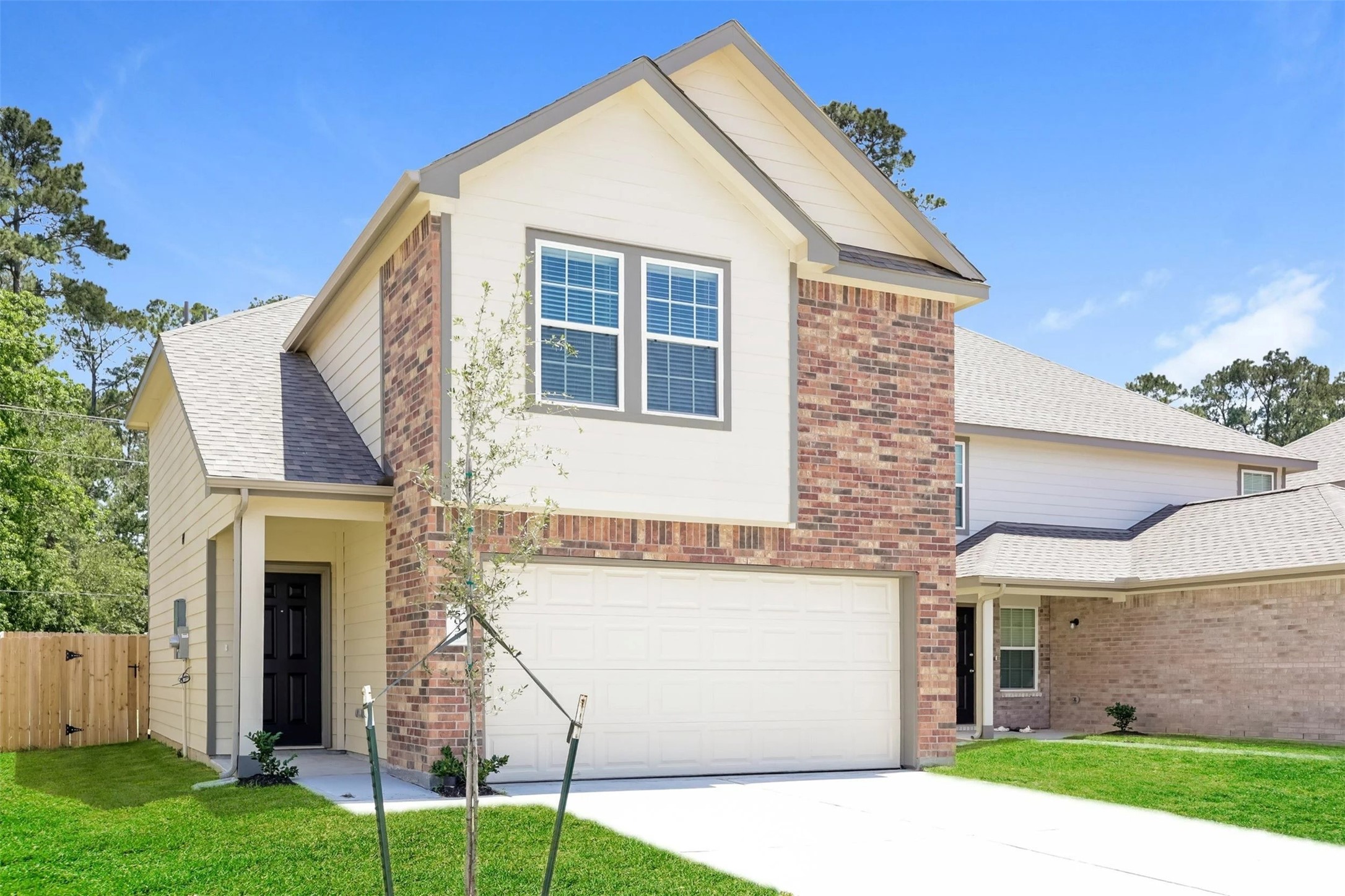 5030 Banyan Tree Trail Spring, TX 77373 - Photo 2 of 18 a view of a white house with a small yard and a palm tree