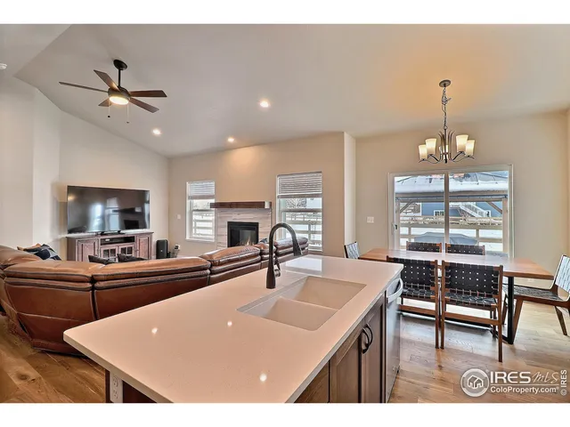 a kitchen with kitchen island a sink table and chairs