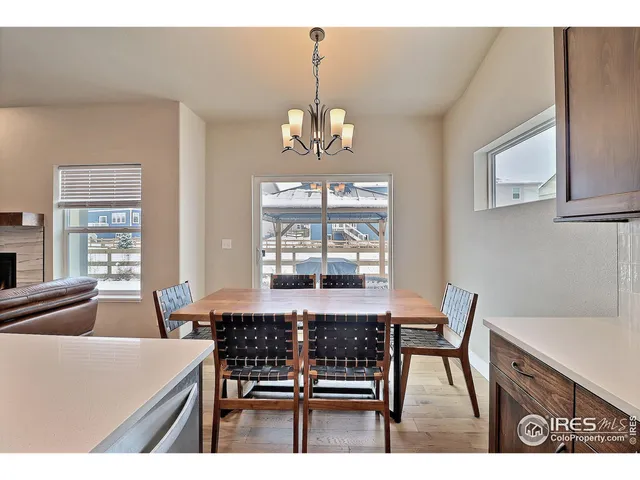 a dining room with wooden floor and a window