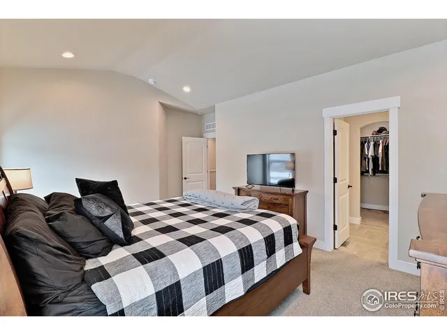 a bedroom with a bed and a television