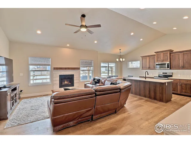 a living room with stainless steel appliances kitchen island furniture and a kitchen view