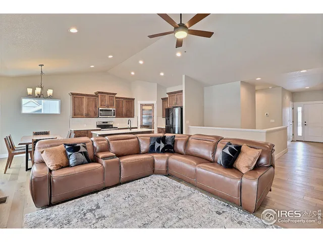 a living room with furniture and a view of kitchen
