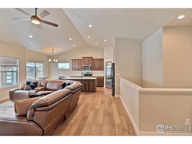 a living room with furniture and kitchen view