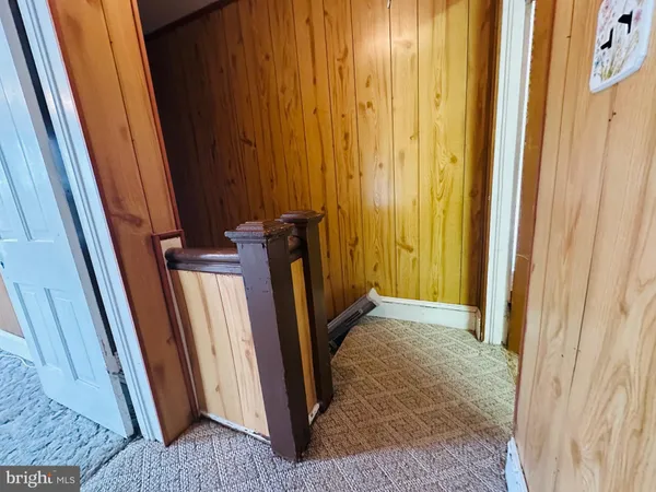 a view of a closet with wooden floor
