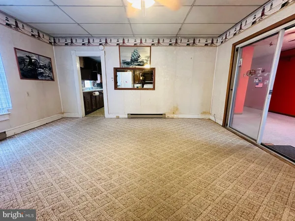 a view of a refrigerator in kitchen and a sink