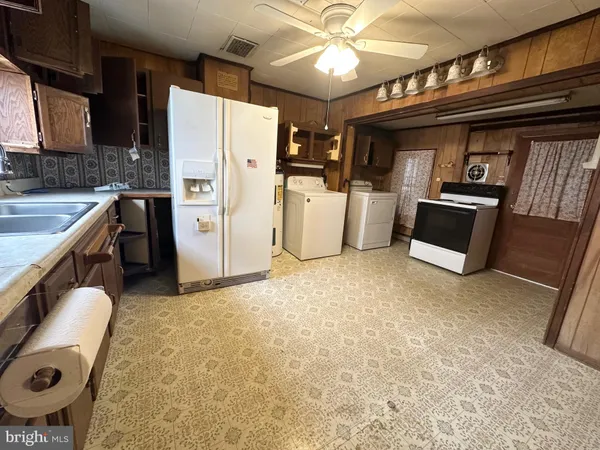 a kitchen with refrigerator and cabinets