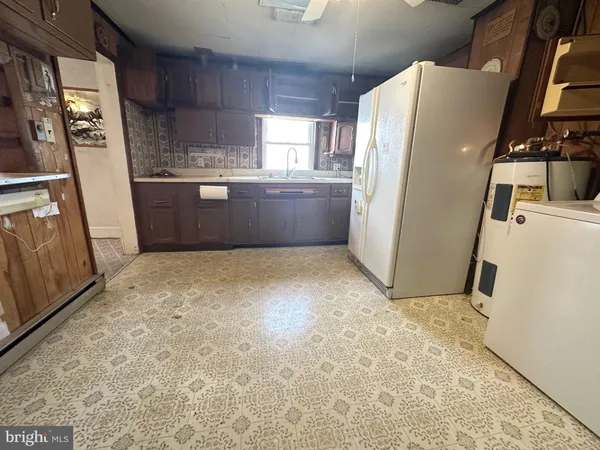 a kitchen with refrigerator a microwave and sink