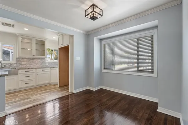 a spacious bedroom with a bed and a chandelier