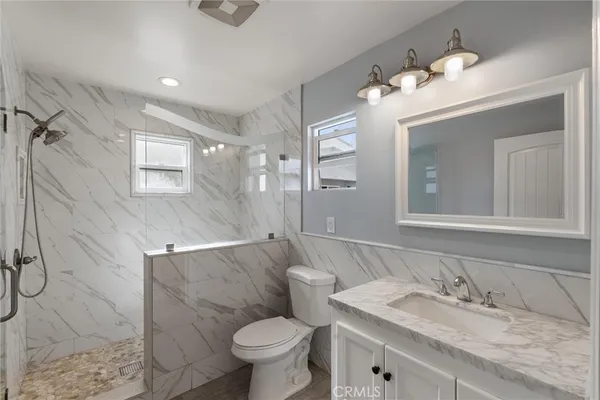 a bathroom with a shower and a sink