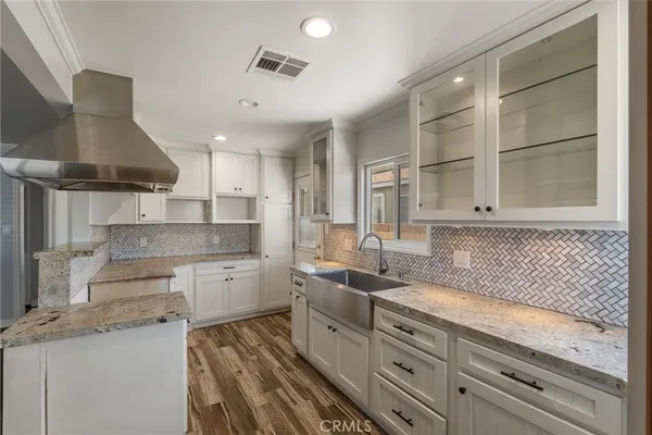 a bedroom with a large bed and potted plants