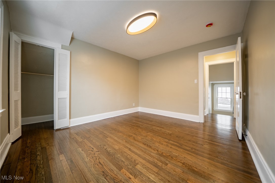3816 Summit Park Road Cleveland Heights, OH 44121 - Photo 18 of 35 Unfurnished bedroom with dark wood-style flooring and a closet