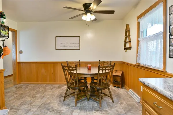 a view of a dining room with furniture and a chandelier