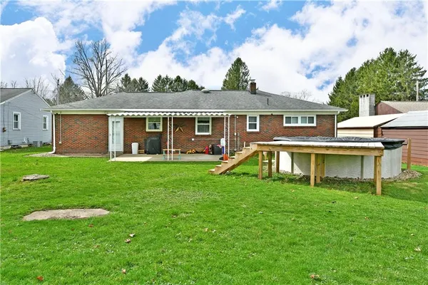 a view of a house with a yard and sitting area
