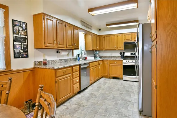 a kitchen with stainless steel appliances granite countertop a sink stove and cabinets