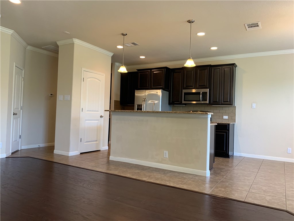 14001 Avery Ranch Boulevard, Unit 2902 Austin, TX 78717 - Photo 4 of 14 a view of a kitchen with a sink and a refrigerator