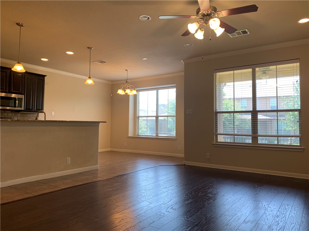 14001 Avery Ranch Boulevard, Unit 2902 Austin, TX 78717 - Photo 6 of 14 a view of an empty room with wooden floor and a window