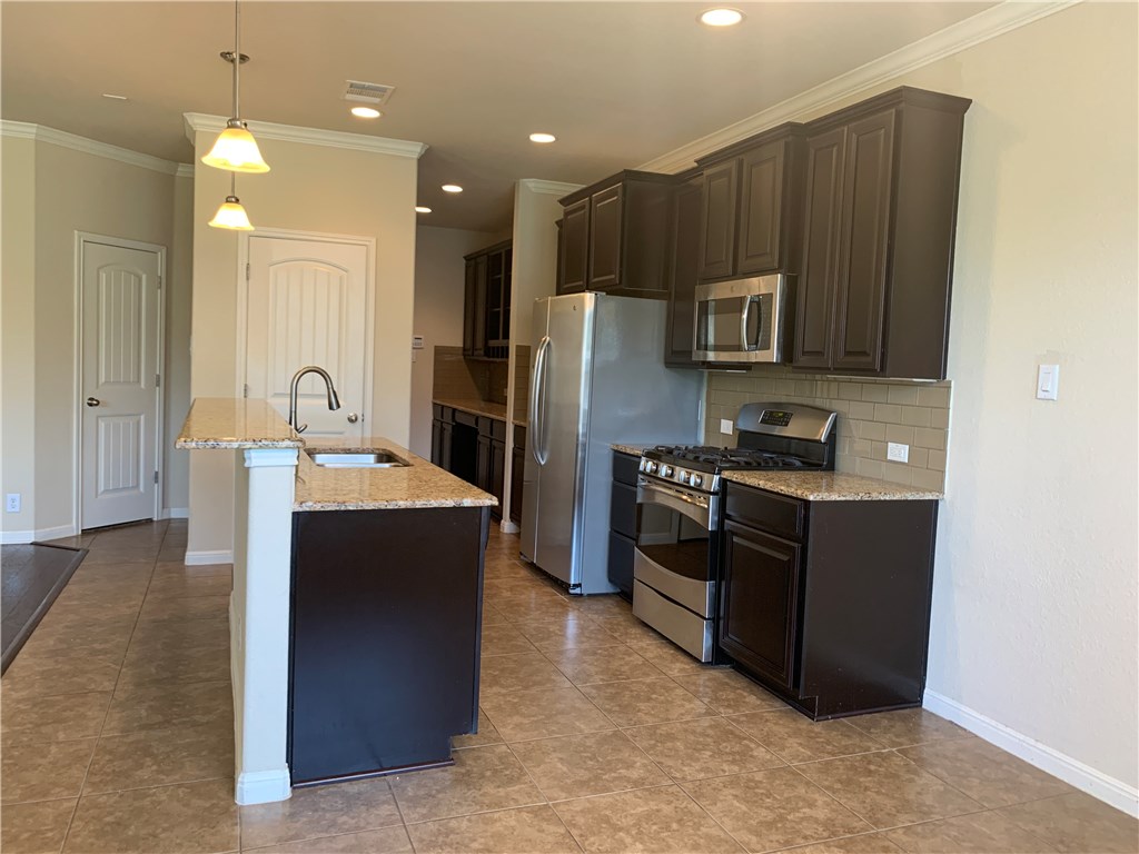 14001 Avery Ranch Boulevard, Unit 2902 Austin, TX 78717 - Photo 8 of 14 a kitchen with stainless steel appliances granite countertop a refrigerator and a stove top oven