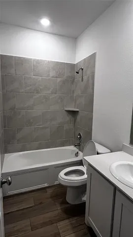 a bathroom with a sink a toilet and a bathtub