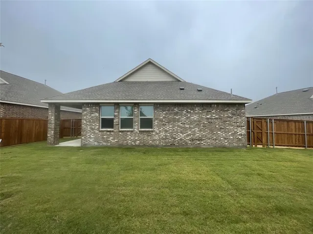 a view of a house with a yard and a garage
