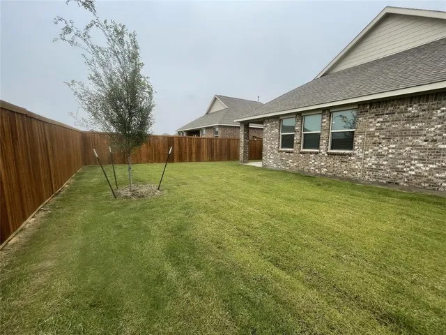 a view of a house with a yard and sitting area