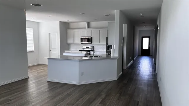 a view of kitchen with wooden floor