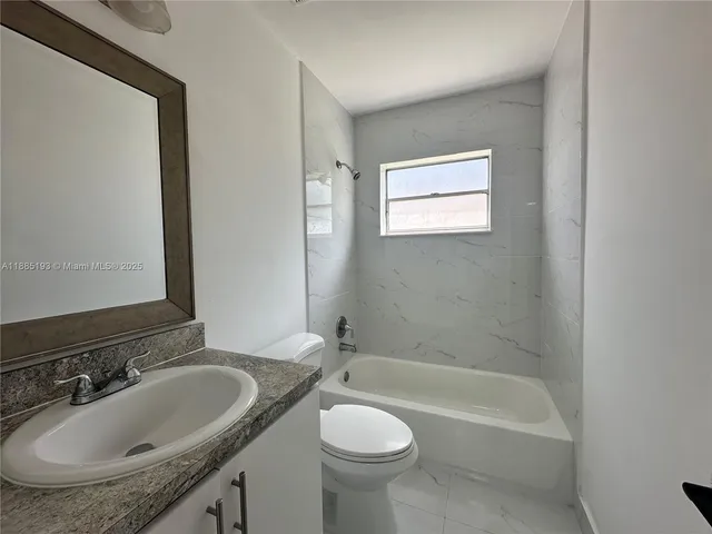a bathroom with a sink a toilet and bathtub