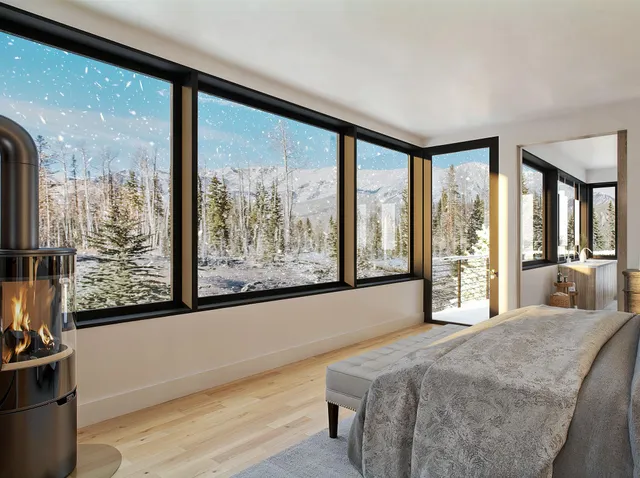 a bedroom with a large window and a bed