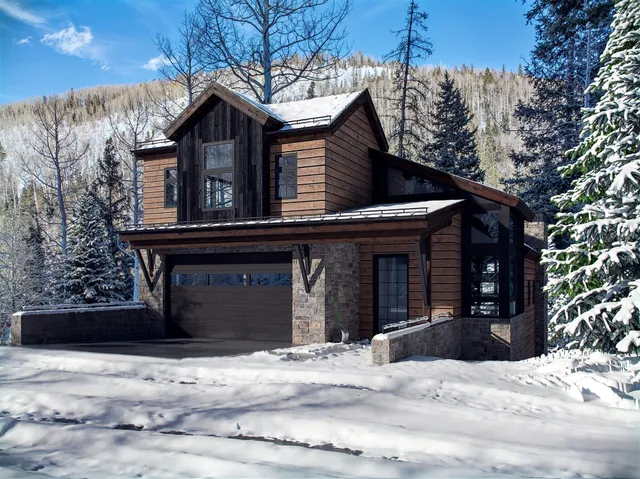 a view of a house with a tree in front