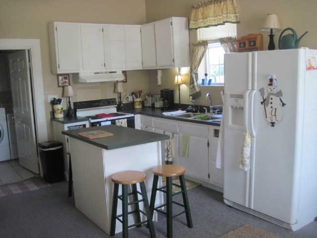 6526 Beckwith Road Mount Juliet, TN 37122 - Photo 10 of 13 a kitchen with stainless steel appliances a stove a refrigerator a sink a stove and white cabinets