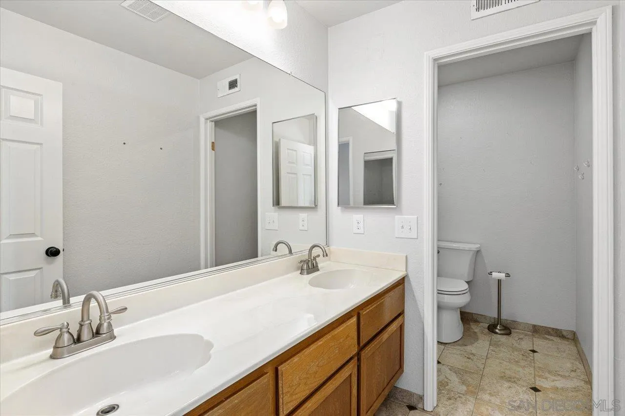 331 Vista Marazul Oceanside, CA 92057 - Photo 15 of 27 a bathroom with a sink and a mirror