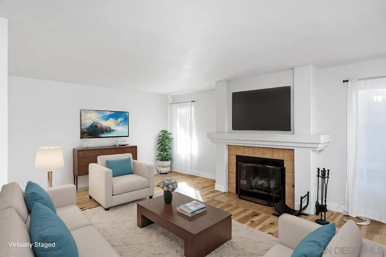 331 Vista Marazul Oceanside, CA 92057 - Photo 7 of 27 a living room with furniture a flat screen tv and a fireplace